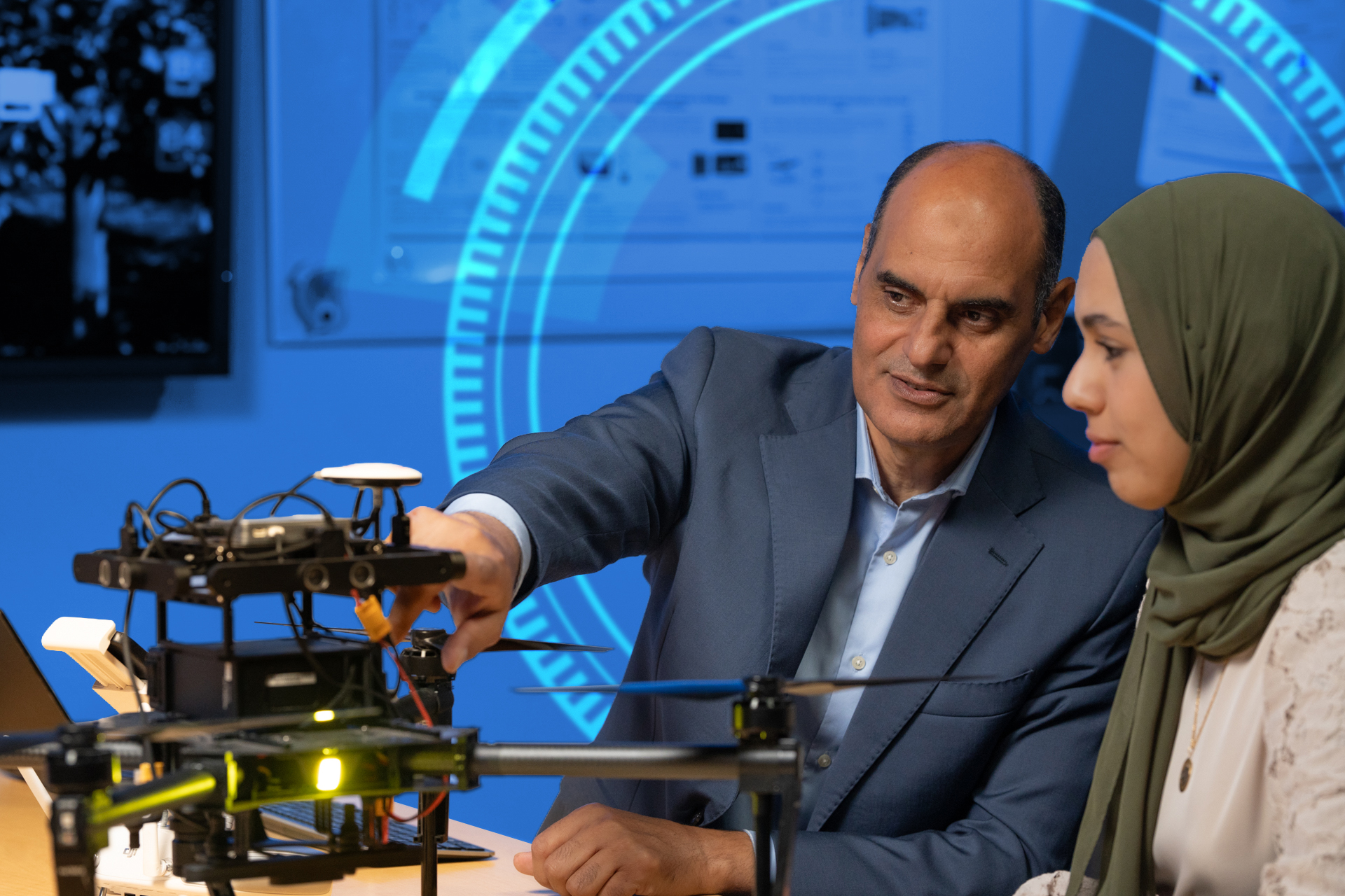 Khalid Elgazzar with students in a research lab