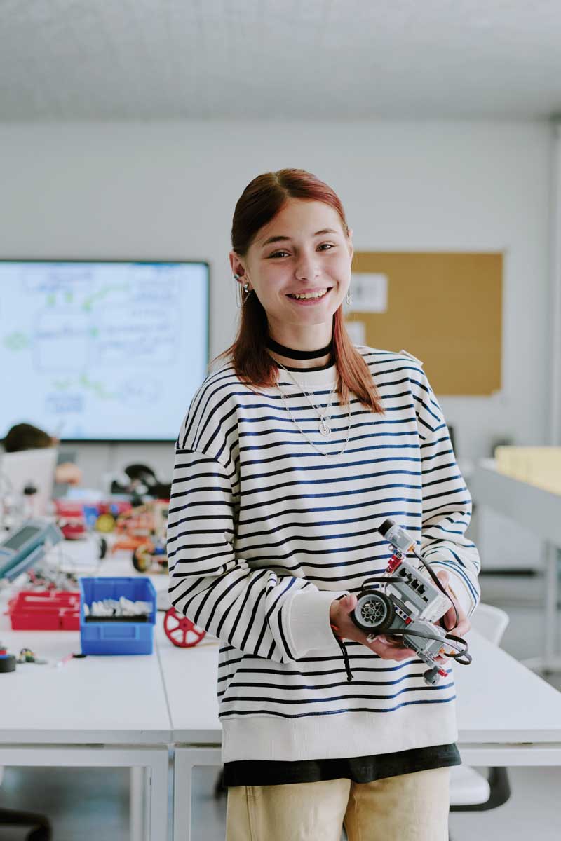 Girl playing with robot